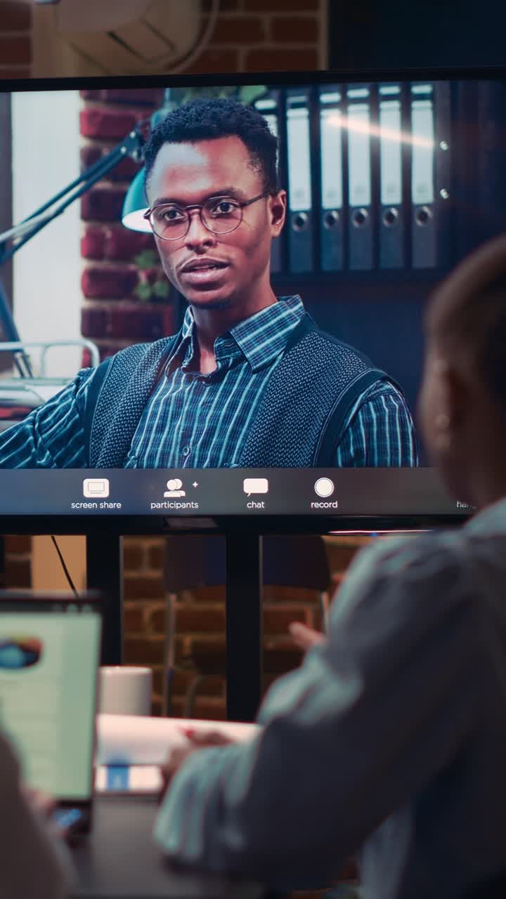 Vertical video: Remote team leader listening to employees report in videocall