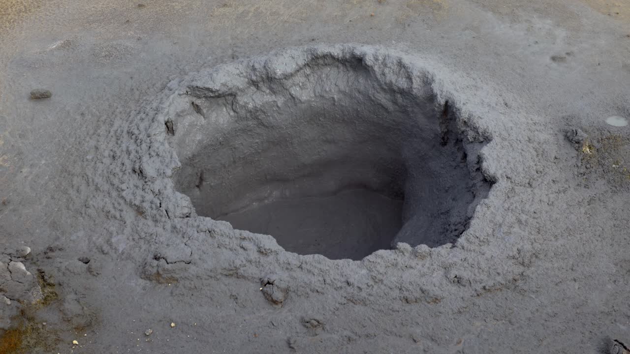 Boiling sulfuric mud spring at high temperature in the geothermal region of Námaskarð, in Iceland