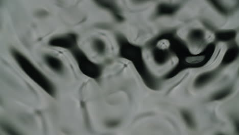 extreme macro shot of water forming different waves and ripples