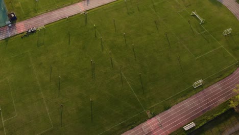 women playing football match. aerial tilt down forward