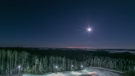 Heavy-equipment-at-a-ski-resort-making-a-jump-under-the-moon-and-stars---time-lapse