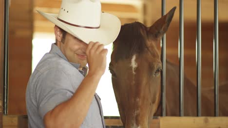 young girl and boy grooming horses in a stable