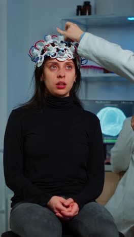 woman undergoing eeg brain activity monitoring in a medical laboratory