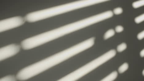 close up of window shutters' shadow on a wall in the morning sun