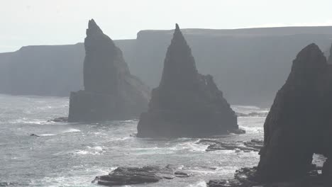 zoom in on the majestic duncansby stacks in scotland, a stunning coastal formation rising proudly from the wild ocean