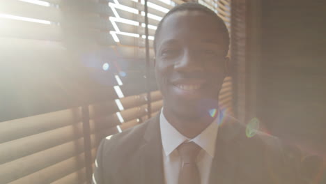 portrait of cheerful black businessman in office