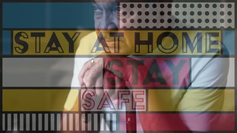 Animation of stay at home stay safe over worried senior man at home