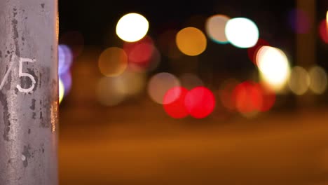 blurred city lights with a numbered pole