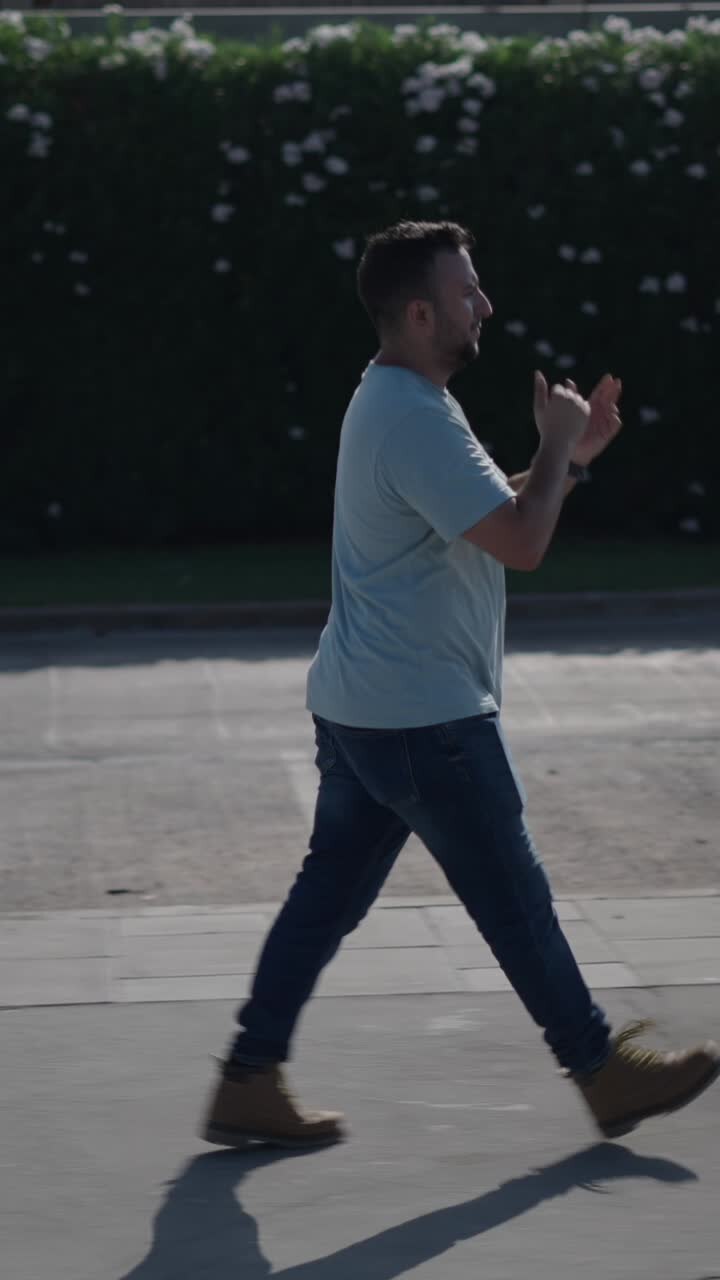 Man walking outdoors on a sunny day