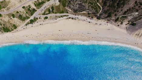top down drone shot of myrtos beach in kefalonia island with turquoise water and white pebbles. static shot