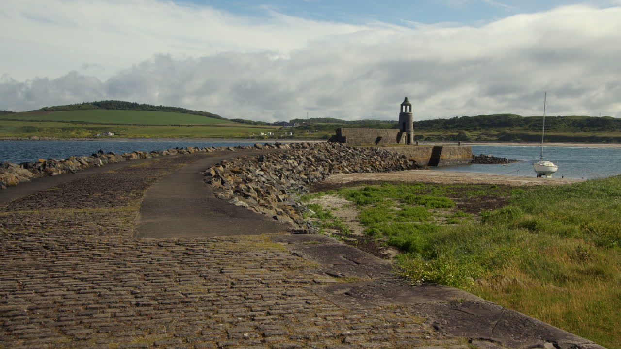 wide shot off the stone road leading onto port Logan harbour
