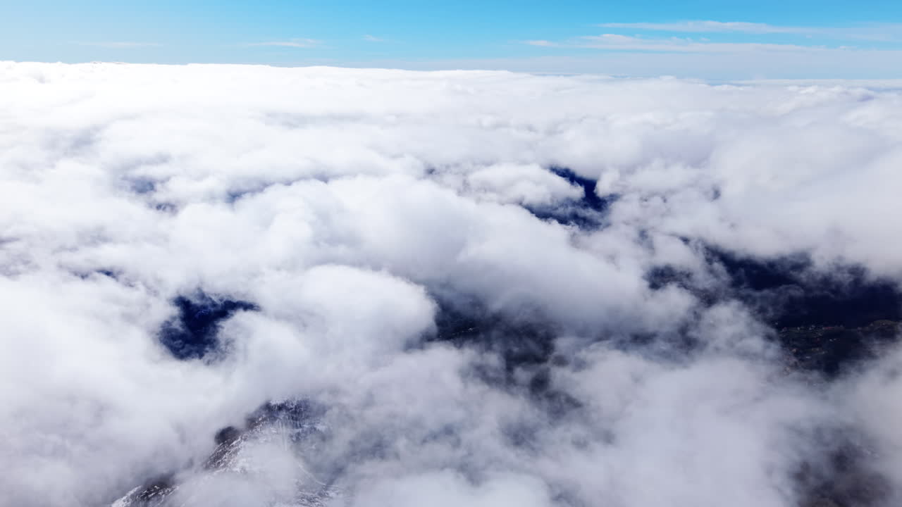 Clouds over snowy mountains evoke tranquility and peace