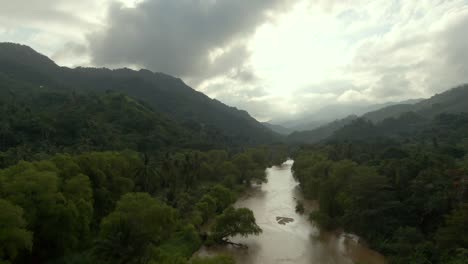 dramatic sky over tuito river in dense thicket of yelapa in jalisco, mexico. aerial drone shot