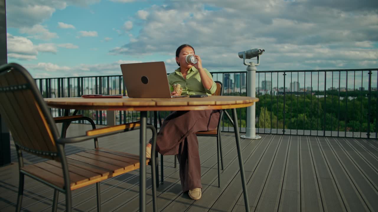 Woman working on laptop outdoors