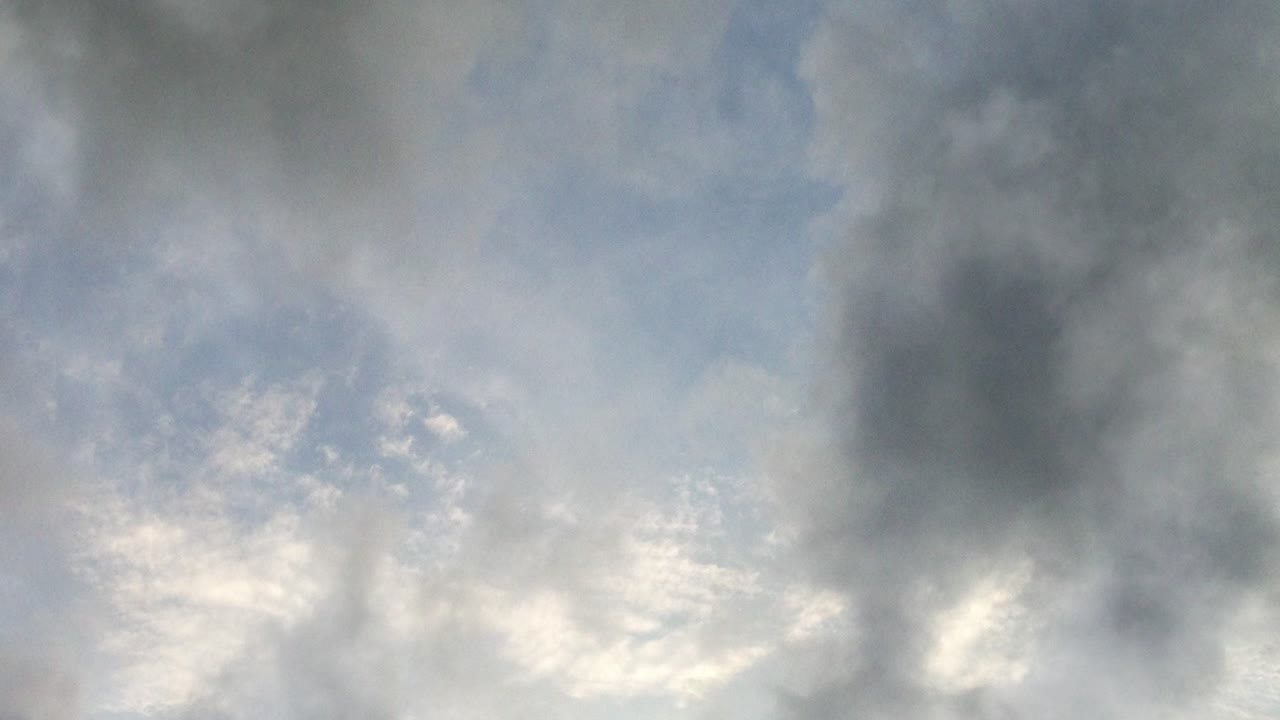point of view, a bright blue sky with dark clouds around it