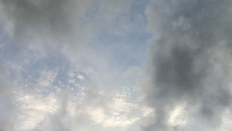 point-of-view,-a-bright-blue-sky-with-dark-clouds-around-it