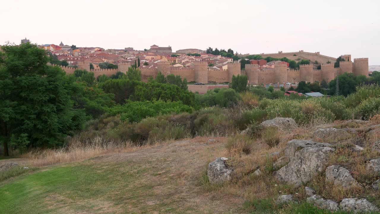 Avila's historic old town and medieval walls, a UNESCO World Heritage Site, seen in a sweeping landscape view.