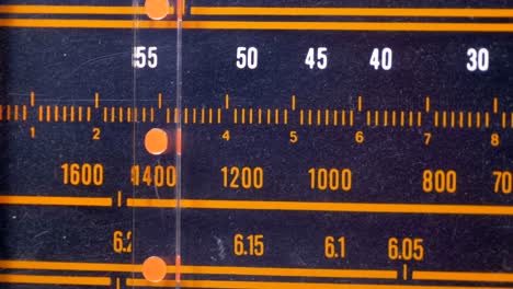 tuning analog radio dial frequency on scale of the vintage receiver