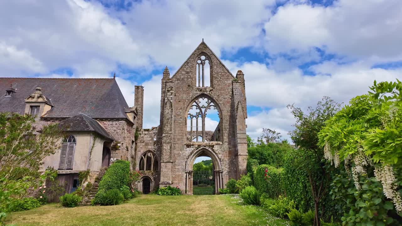 Ruins of historic Beauport Abbey, gothic architecture, lush gardens, Paimpol, Brittany, France. First-person walking