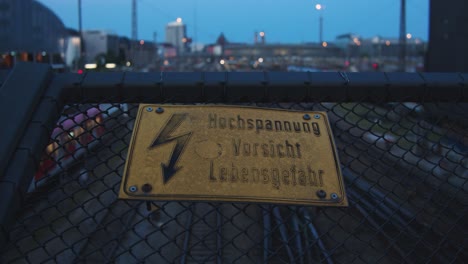 sign: high voltage - hochspannung - danger - over train tracks