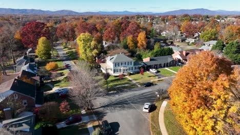 aerial establishing shot of two story white home during autumn fall foliage in usa