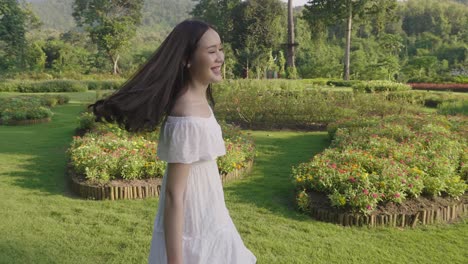 young girl happy in a garden of flowers