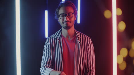 stylish man posing in neon lighting