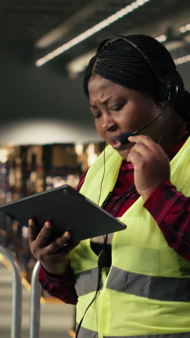 Vertical Video Black female agent assisting customers with package tracking and delivery status