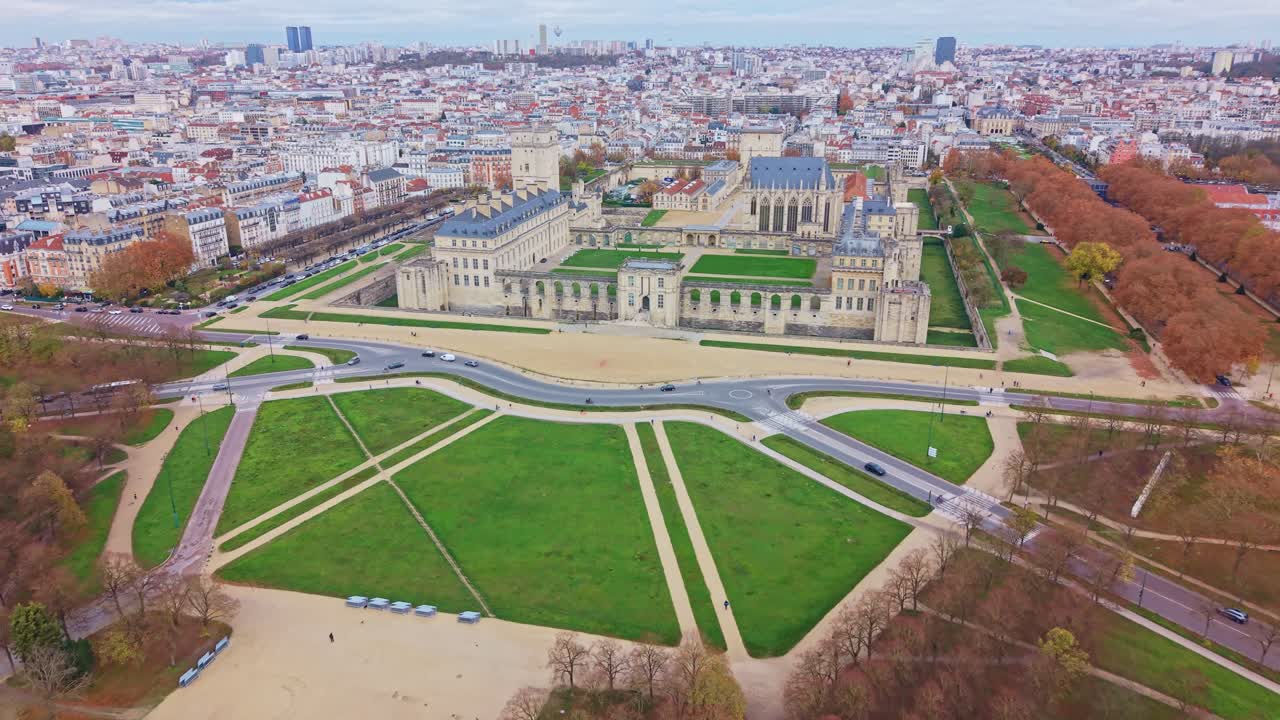 Drone fly toward the former fortress and royal residence of Vincennes Castle aka Chateau de Vincennes and palace gardens, Vincennes, France