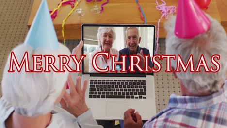 merry christmas text over senior couple having a videocall on laptop during christmas