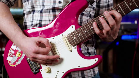 hands man playing guitar