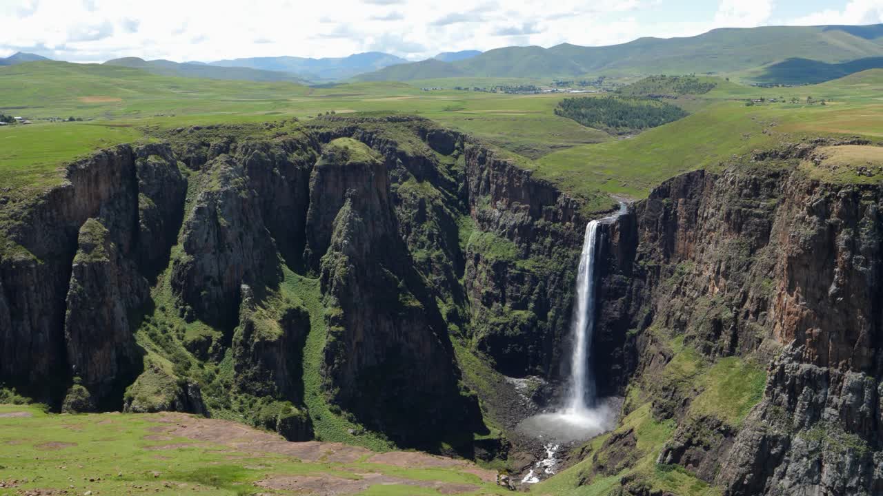 pan a la derecha a través de la escena del cañón de cascada verde vivo en lesotho áfrica
