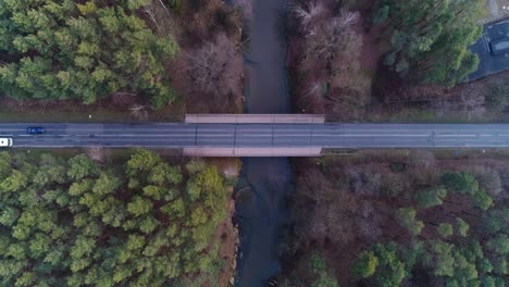 traffic crossing bridge over mala panew river in winter, overhead aerial