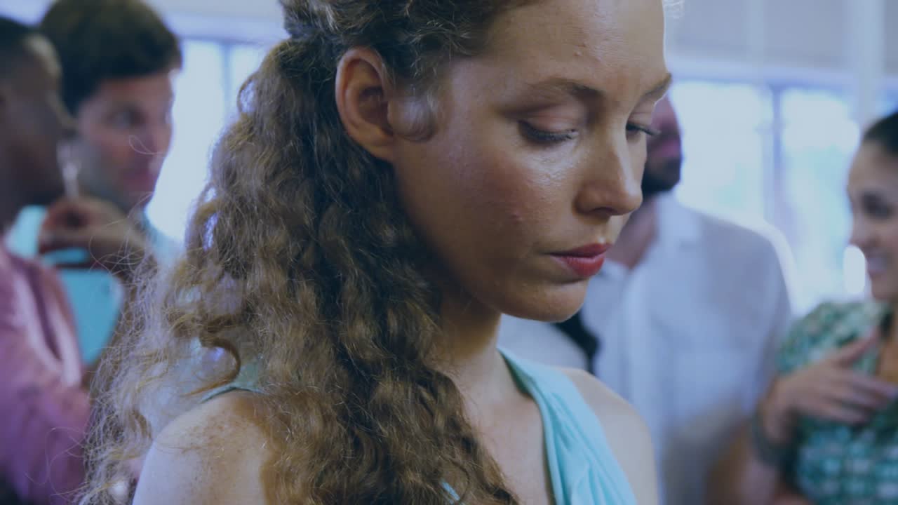 Woman standing in bright tech space reacting to falling green binary code intensifying focus