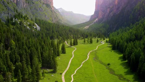 scenic mountain valley with sheer rock and wooded hills in vallunga, south tyrol, italy - drone shot