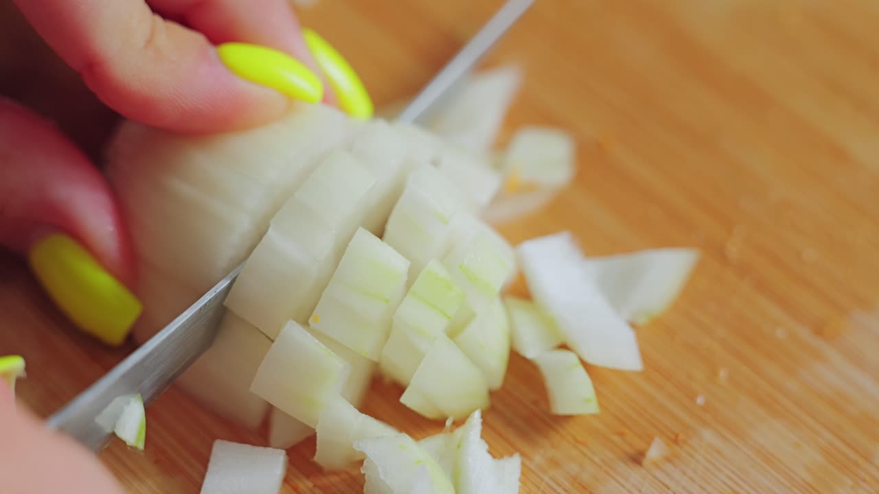 Domestic cooking moment, onion preparation in shallow focus Baltic kitchen