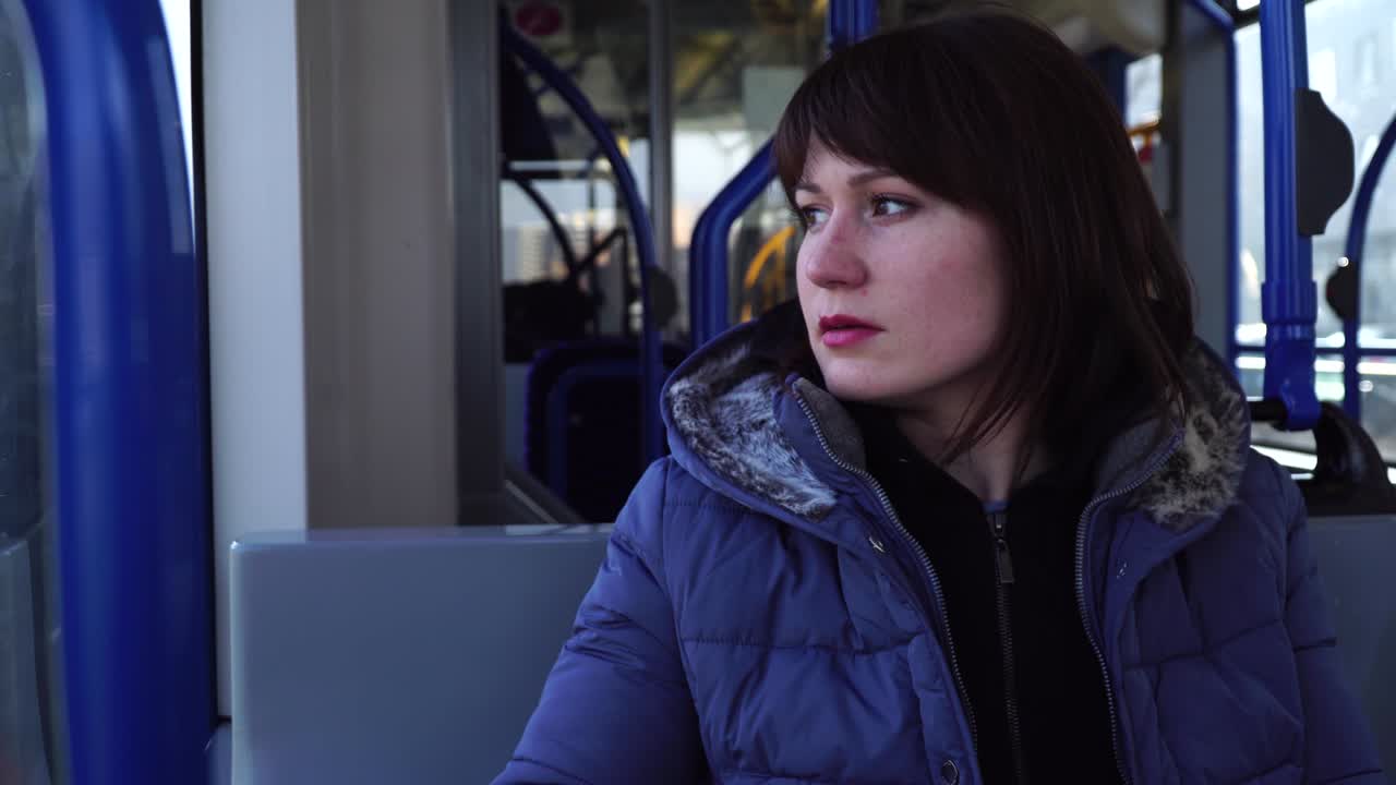 mujer sentada en un tranvía a ámsterdam y mirando por la ventana