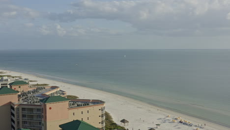 Fort-Myers-Beach-Florida-Aerial-v14-pan-left-shot-of-Gulf-of-Mexico,-beach,-resorts-and-Matanzass-Pass---March-2020