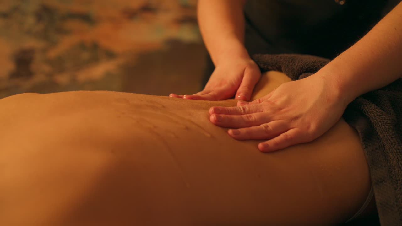 Masseuse Spreading Oil And Massaging Clients Back. - closeup shot