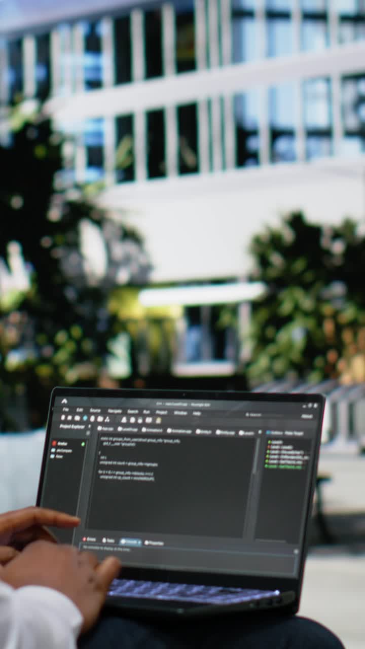 Vertical Video African american guy works on programming code on terminal window