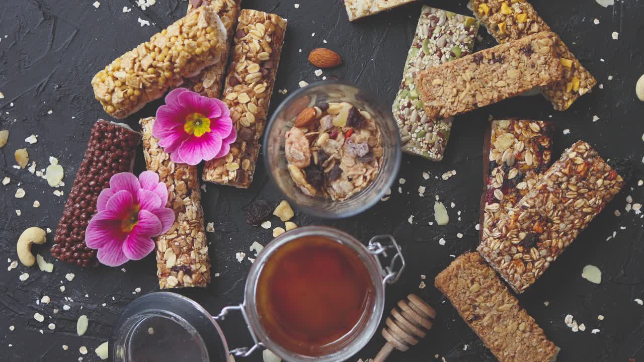 Healthy superfood composition  Various kinds granola energy protein bars with honey in jar