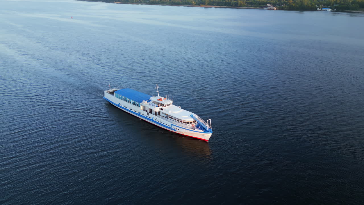 A Passenger Boat Cruising on a Calm River