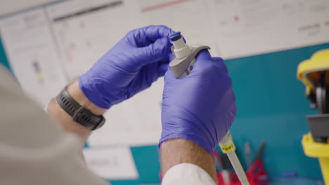 Lab-Worker-Inserts-Clear-Liquid-in-Test-Tube-with-Micro-Pipette,-Close-up