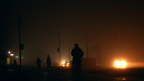 foggy night street scene with people