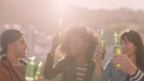 group of multi ethnic friends celebrating rooftop party making toast drinking alcohol enjoying reunion celebration on weekend social gathering at sunset