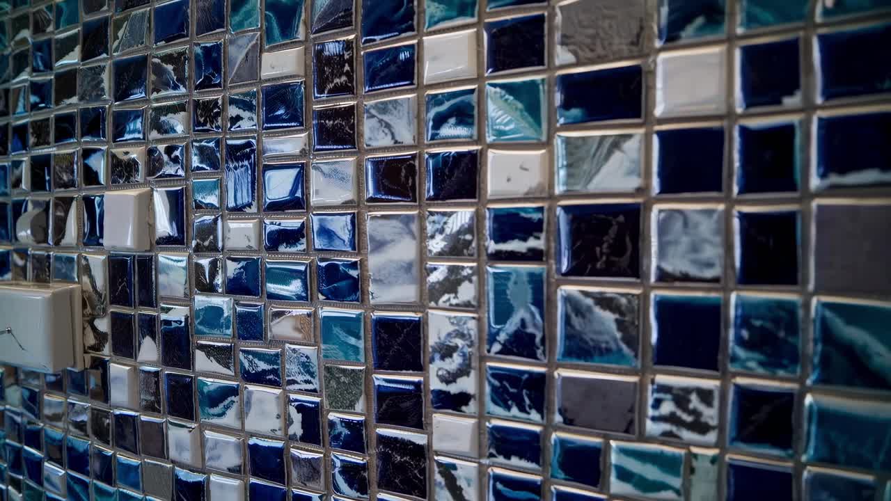 Wide-angle video shot of a luxurious kitchen with dark wood cabinets, marble countertops