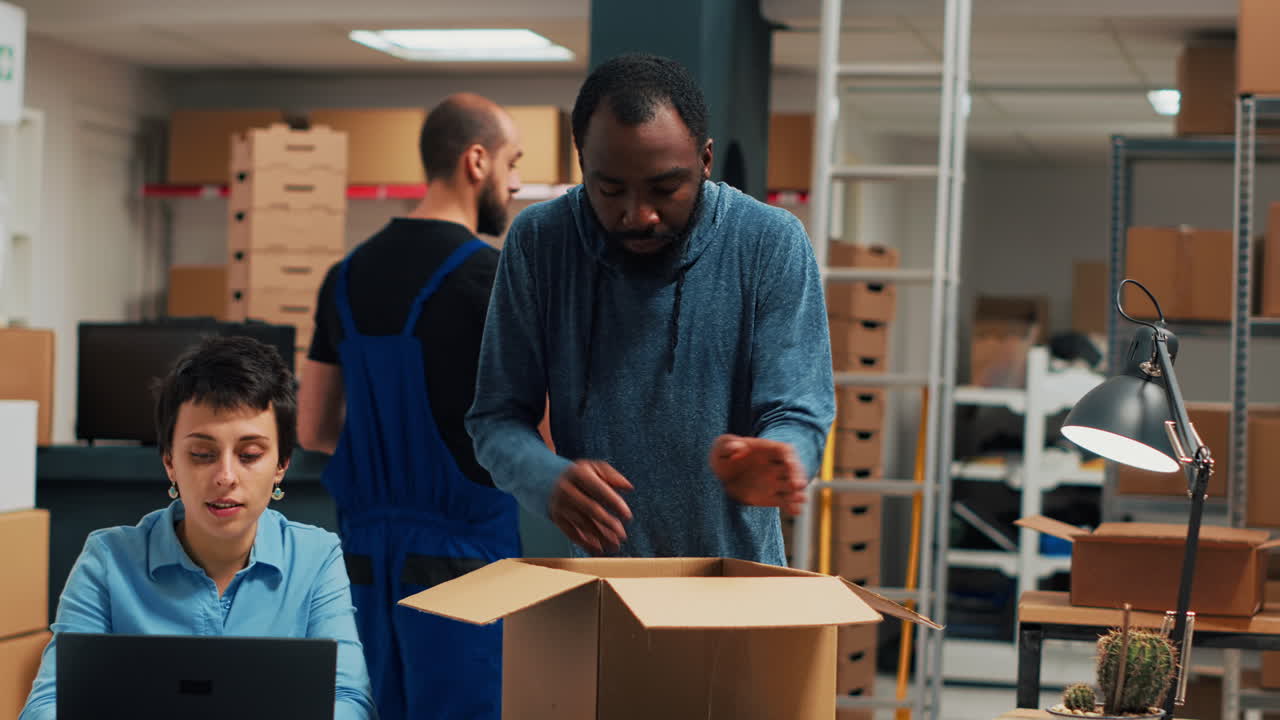 Warehouse logistics team inspecting a box with helmet and cardboard boxes