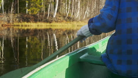 person out canoeing in the sunshine during fall