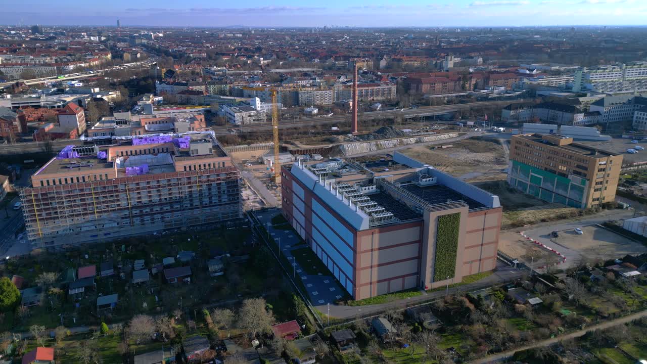 Moderno edificio di data center caratterizzato da una facciata a parete verde, che rappresenta l'infrastruttura tecnologica e il calcolo sostenibile in un paesaggio urbano. Panorama aereo perfetto, drone statico in hovering