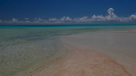 pink sands, the most beautiful tropical beach of the atoll of fakarava, french polynesia  with crystal clear water of the blue lagoon in the background